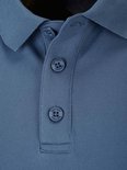 Detail van de knopen van een blauw poloshirt met geborduurd logo.