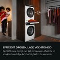 Vrouw met kind bij een AEG wasmachine en droger in een moderne badkamer.