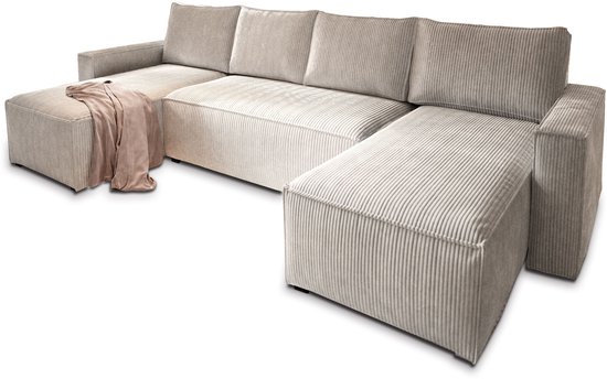 Crèmekleurige U-vormige bank van corduroy met een plaid in de hoek.
