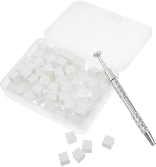 Een open plastic doos vol met kleine witte kubusvormige nagelsponzen, met een zilverkleurig nagelgereedschap ernaast.