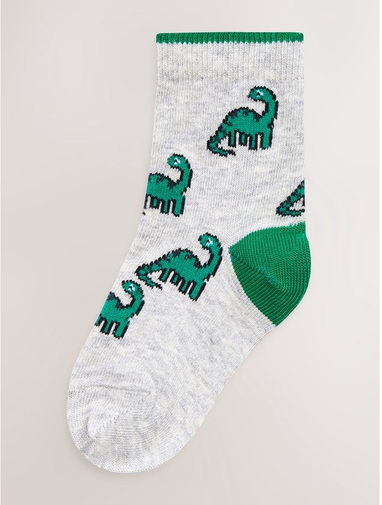Lichtgrijze sokken met een print van groene dinosaurussen en groene tenen.