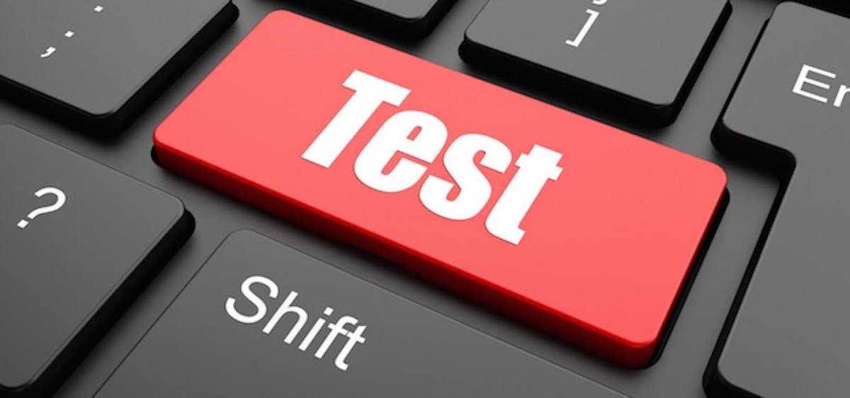 Een rode toets met het woord "Test" in witte letters erop, op een zwarte toetsenbord.