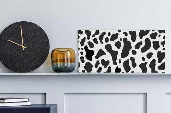 Peinture sur toile Une illustration du motif à pois d'une vache - 40x20 cm - Décoration murale