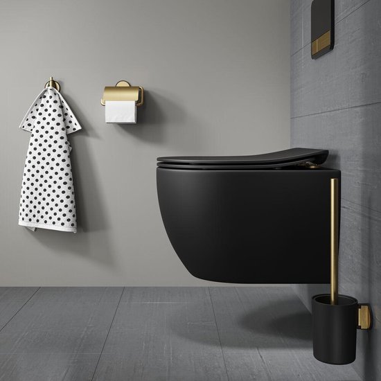 Toilette noir moderne avec accents dorés, porte-rouleau et serviette à pois.