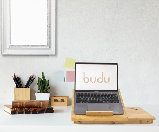 Bamboe laptoptafel met Budu logo op het scherm, geplaatst op een bureau met boeken en een cactus.