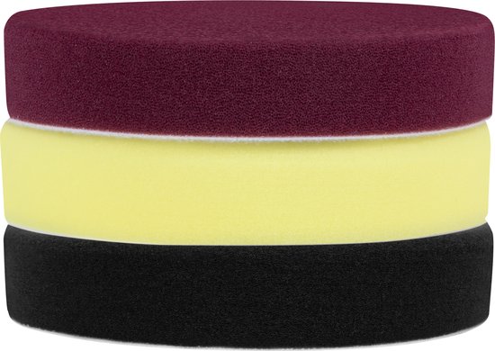 Stapel van drie ronde polijstschijven: bordeauxrood bovenaan, geel in het midden en zwart onderaan.