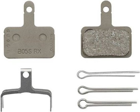 Plaquette de frein Shimano B05S RX avec surface rugueuse, un support métallique et trois goupilles argentées.