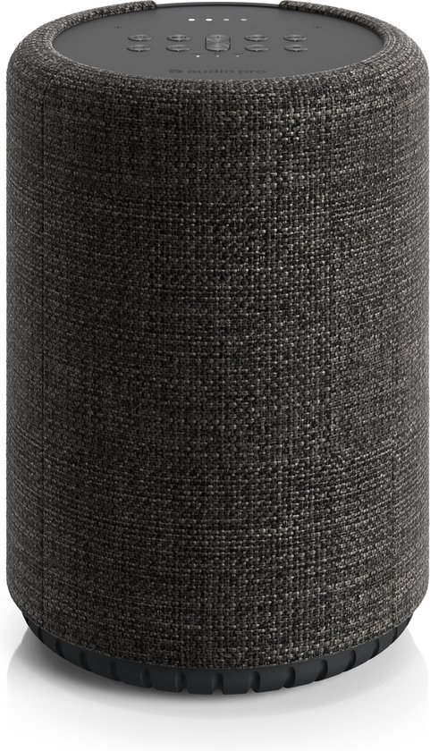 Donkergrijze cilindrische luidspreker met stoffen bekleding en bedieningsknoppen bovenop.