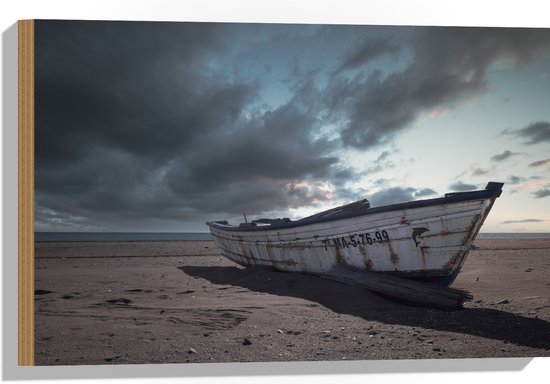WallClassics - Hout - Witte Boot op het Strand onder Donkere Wolken - 60x40 cm - 12 mm dik - Foto op Hout (Met Ophangsysteem)