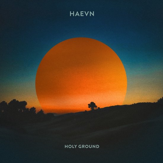 HAEVN Holy Ground 3" CD Single hoes met een oranje cirkel, zonsondergang en silhouetten van heuvels en bomen.