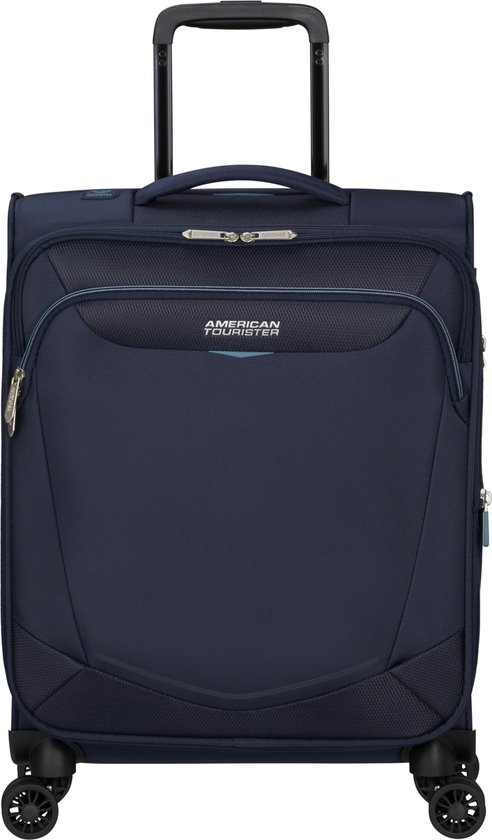 Donkerblauwe American Tourister spinner reiskoffer met handvat en wielen.