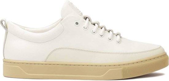 White leather sneakers on a beige sole