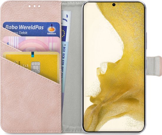 Étui de téléphone rose ouvert avec téléphone, cartes bancaires et billets.
