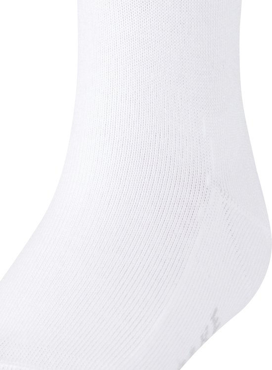 Close-up van een witte Falke kniekous met ribbelstof en logo.