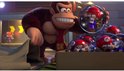 Donkey Kong houdt een kleine Mario in een bubbel vast, met een doos vol Mario's in bubbels.