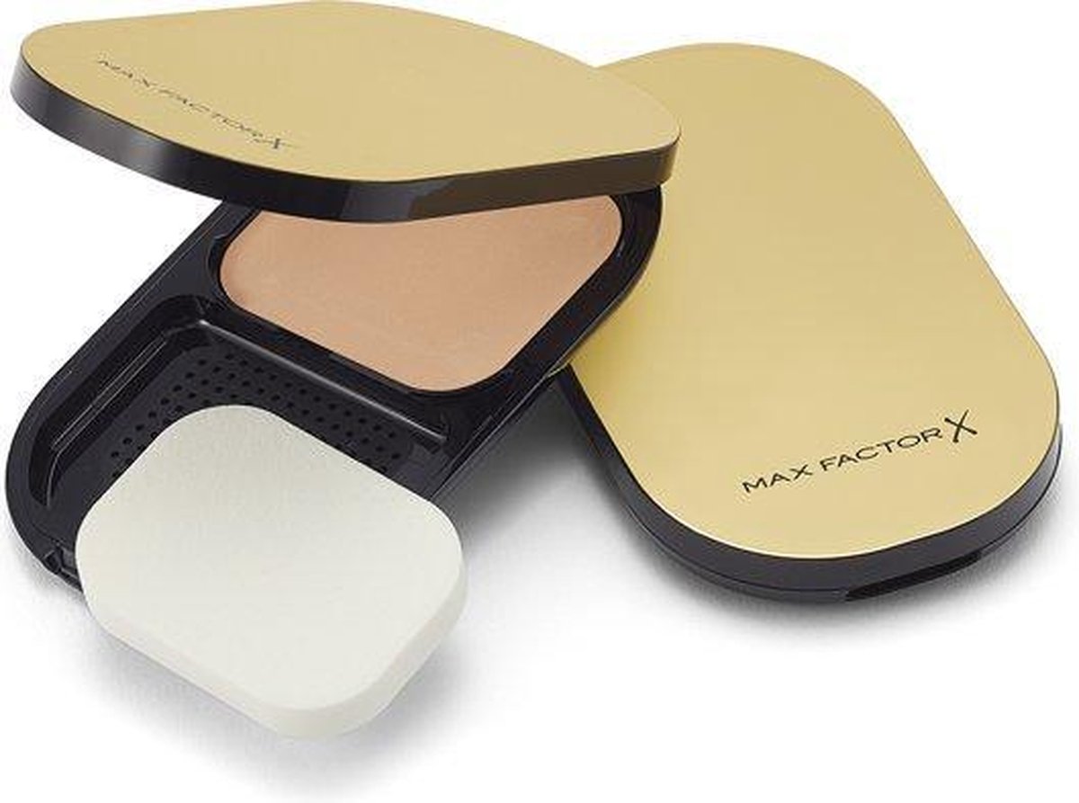 Gouden, ovale compacte poederdoos met "MAX FACTOR X" logo.