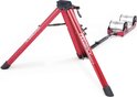 Een rode Feedback Sports Fietstrainer met twee zilveren rollen.