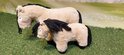 Twee beige Crafty Ponies knuffels met zwarte manen en staarten, op groen gras.