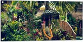 WallClassics - Tuinposter – Stenen Beeld in Park vol Planten - 100x50 cm Foto op Tuinposter (wanddecoratie voor buiten en binnen)