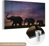 MuchoWow® Glasschilderij 80x40 cm - Schilderij acrylglas - Olifanten - Zonsondergang - Silhouette - Foto op glas - Schilderijen