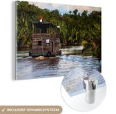 MuchoWow® Glasschilderij 60x40 cm - Schilderij acrylglas - Boot op een rivier in het Nationaal park Tanjung Putung in Indonesië - Foto op glas - Schilderijen