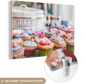 MuchoWow® Glasschilderij 120x80 cm - Schilderij acrylglas - Een tafel vol met cupcakes - Foto op glas - Schilderijen