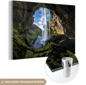 MuchoWow® Glasschilderij 150x100 cm - Schilderij acrylglas - Waterval buiten een grot in IJsland - Foto op glas - Schilderijen