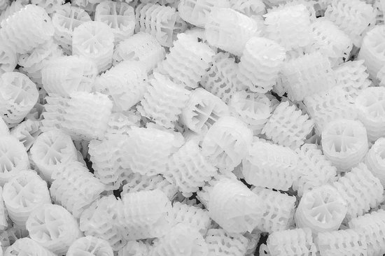Close-up van vele witte Hel-X 17 mm biocarriers, ook wel filtermedia, met een honingraatstructuur.
