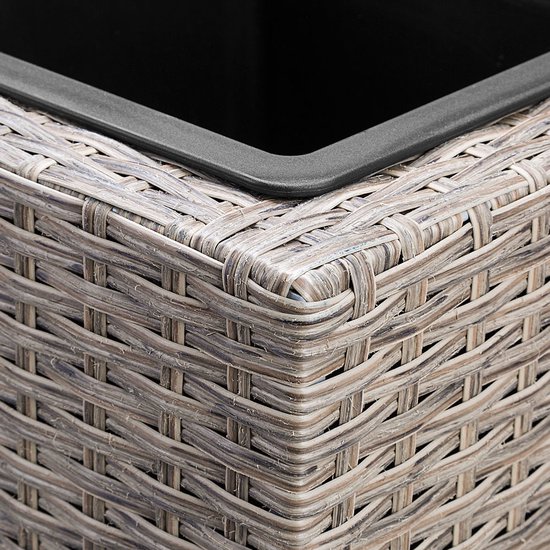 Detail van de hoek van een beige plantenbak met vlechtstructuur en een zwarte rand.