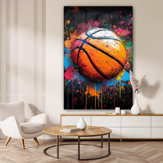 Peinture d'un ballon de basket éclaboussé de touches de peinture vive.