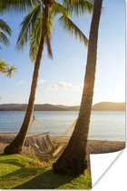 Poster Twee palmbomen op het strand met een hangmat - 40x60 cm