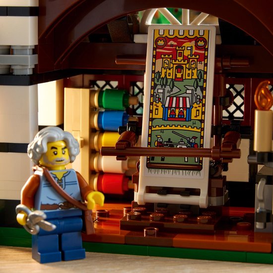 Middeleeuws LEGO-weefgetouw met gekleurde draden en een banier met kasteelafbeelding.