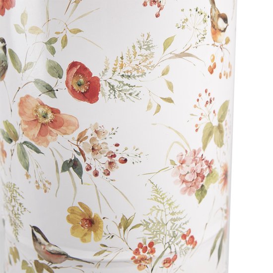 Detail van witte emmer met een patroon van rode, oranje en gele bloemen met groene bladeren en vogels.