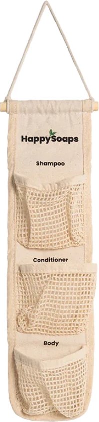 Beige stoffen organizer met drie gaasvakken voor zeep. Met het logo van HappySoaps, en de tekst 'Shampoo', 'Conditioner', 'Body'.