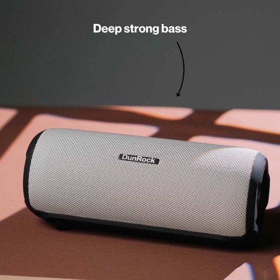 DunRock speaker in grijs met zwarte randen, op een houten ondergrond.
