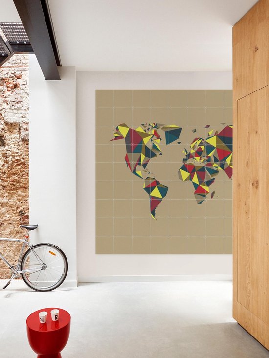 Carte du monde abstraite de style géométrique, accrochée dans un couloir industriel avec un vélo et une table d'appoint rouge.