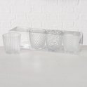 Set van 4 glazen waxinelichthouders, elk met een ander patroon: verticale lijnen, ruitjes, sterren en bolletjes.