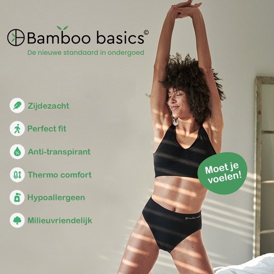 Vrouw strekt zich uit in een zwarte crop top en bijpassende slip met tekst: "Bamboo basics De nieuwe standaard in ondergoed".