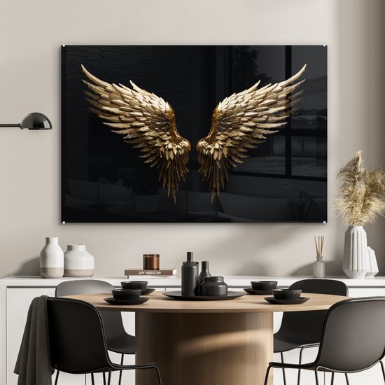 Gouden engelenvleugels op zwarte achtergrond boven een eettafel.