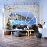 Fotobehangkoning - Behang - Vliesbehang - Fotobehang Uitzicht op Shipwreck Beach vanuit het Raam 3D - Look At The Island Of Dreams - 250 x 175 cm
