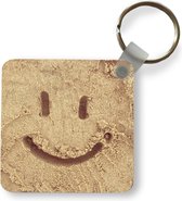 Sleutelhanger - Smiley in het zand - Plastic - Rond - Uitdeelcadeautjes