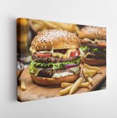 Canvas schilderij - Hamburgers and French fries on the wooden tray.  -     1040760661 - 80*60 Horizontal