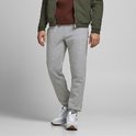 Lichtgrijze joggingbroek met zakken, gedragen door een man met een groene bomberjack.