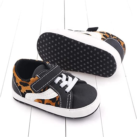 Zwarte babysneakers met luipaardprint en witte veters, de zolen hebben antislip nopjes.