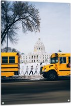 WallClassics - Tuinposter – Gele Schoolbussen bij Gebouw - 80x120 cm Foto op Tuinposter  (wanddecoratie voor buiten en binnen)