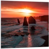 WallClassics - PVC Schuimplaat- Rotsen in de Zee met Zonsondergang - 100x100 cm Foto op PVC Schuimplaat