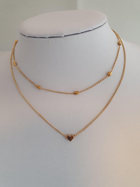 Goudkleurige dubbele ketting met bolletjes en een hartje.