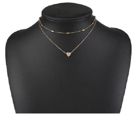 Goudkleurige dubbele ketting met bolletjes en een hartje, op een paspop.