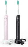 Roze en zwarte Philips Sonicare sonische tandenborstels met opladers.
