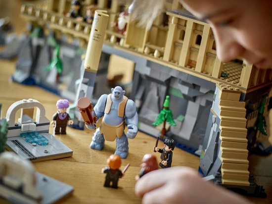 Jeu LEGO Harry Potter Le Grand Hall avec un troll maniant un marteau face à Harry, Ron et Hermione.